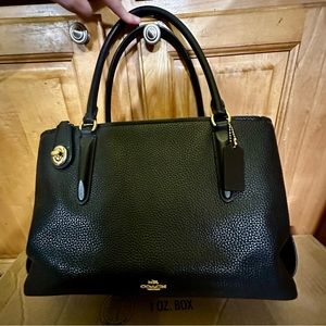 Black and gold Coach bag, medium sized.